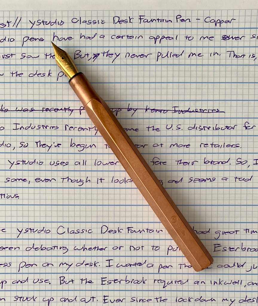 hpto of the ystudio classic desk pen laying on a writing sample